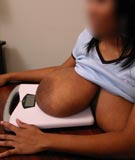 Breast weighing on the big boobs scales to see how much her huge heavy tits weigh with super busty big black boobs of 32MM Cheron at TopHeavyAmateurs.com