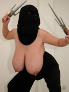 Ninja tits with Maxi 32JJ as a topless ninja with katana Samurai sword and nunchucks and sai stuck in her massive breasts in nunchuck titfuck photos from TopHeavyAmateurs.com