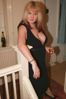 Vix tits-out with a glass of champagne at her BreastFiles Playmate Site