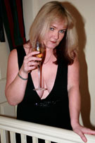Vix tits-out with a glass of champagne at her BreastFiles Playmate Site