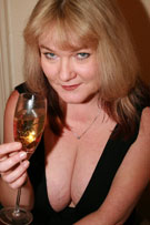 Vix tits-out with a glass of champagne at her BreastFiles Playmate Site