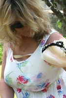 Vix takes her F-cup bra off from under her top to go braless in the garden at Tits-Out.com