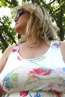 Vix takes her F-cup bra off from under her top to go braless in the garden at Tits-Out.com